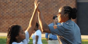 A girl high-fiving a woman - The Game Changers