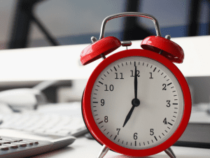 Alarm clock on a desk - 4 Ways Grantmakers Can Streamline Reporting