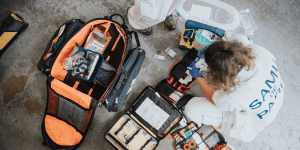 Emergency responder working out of orange supply bag - Front Lines of Philanthropy