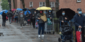 People in masks waiting in line for foodbank - Front Lines of Philanthropy