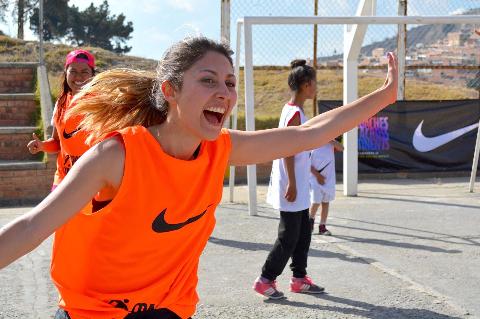 Teen girl playing soccer with teammates