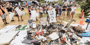 Trash on the ground surrounded by people - Into the Sea